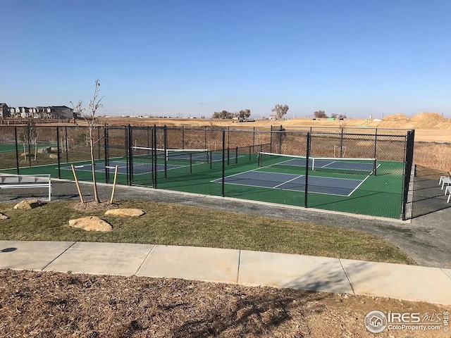 view of tennis court featuring fence