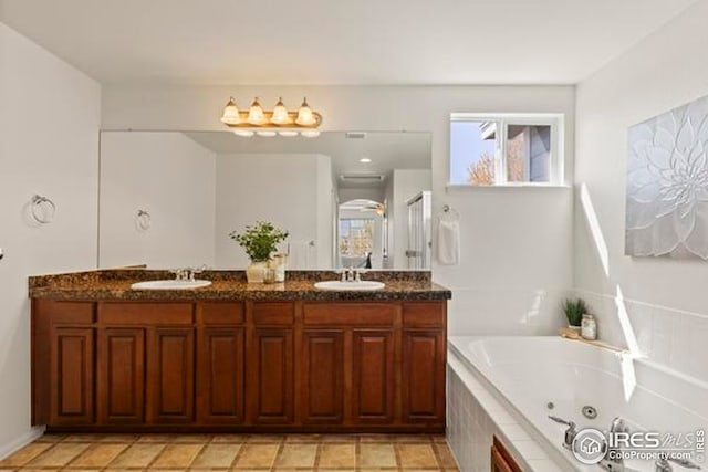 full bath featuring double vanity, a tub with jets, a sink, and a shower