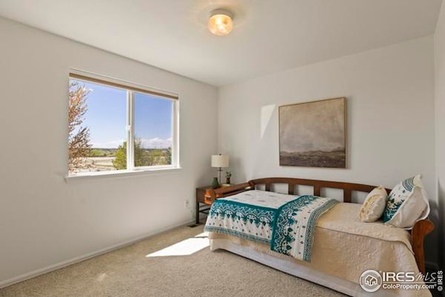 carpeted bedroom with baseboards