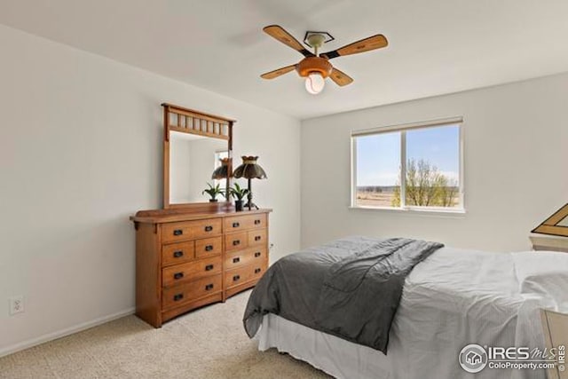 carpeted bedroom with a ceiling fan and baseboards