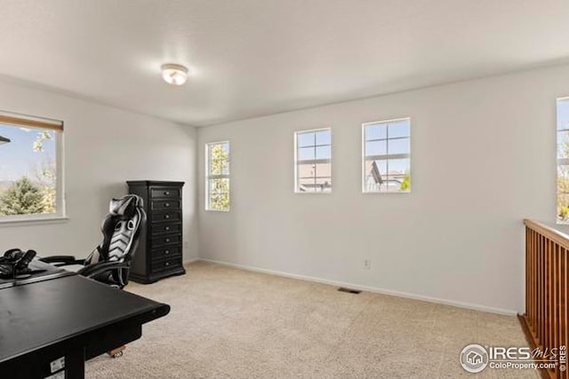 office area with baseboards and light carpet