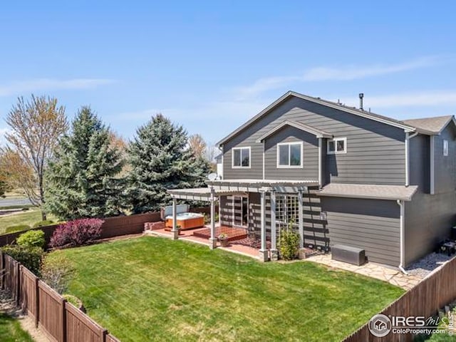 rear view of house with a fenced backyard, a hot tub, a yard, and a pergola