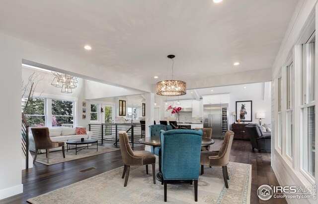 dining space featuring an inviting chandelier, dark wood finished floors, and visible vents