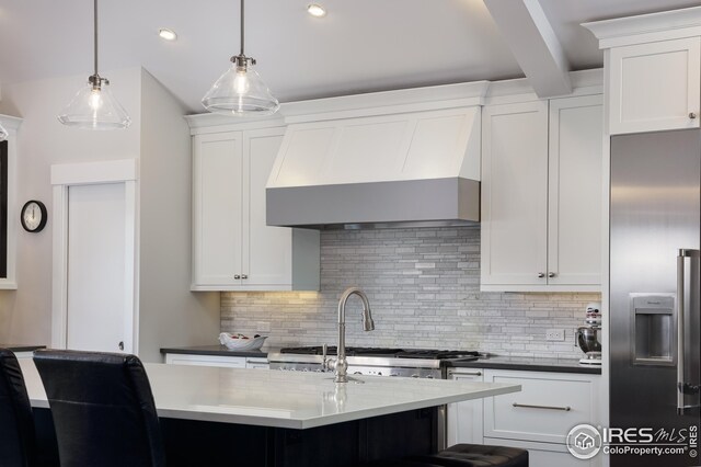 709 Baseline Rd, Boulder, CO 80302 - kitchen featuring high quality fridge, wall chimney exhaust hood, tasteful backsplash, white cabinets, and decorative light fixtures
