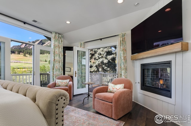 bedroom with multiple windows, visible vents, access to exterior, and lofted ceiling
