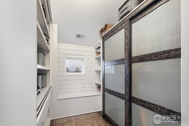 bathroom featuring a sink, an inviting chandelier, a shower stall, and wood finished floors