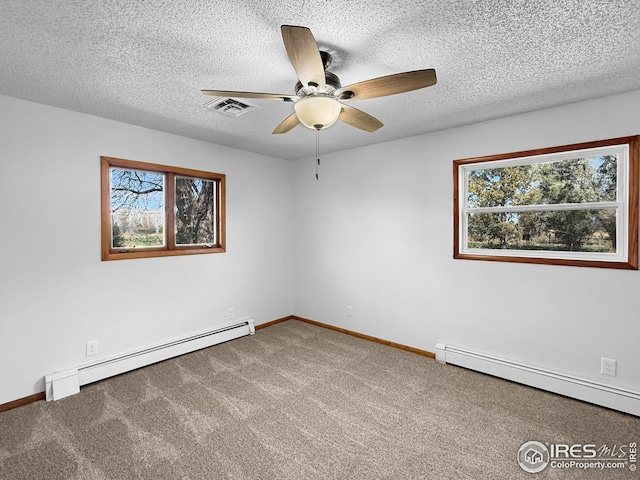 26237 County Road 65, Holyoke, CO 80734 - unfurnished room featuring baseboard heating, ceiling fan, plenty of natural light, and a textured ceiling