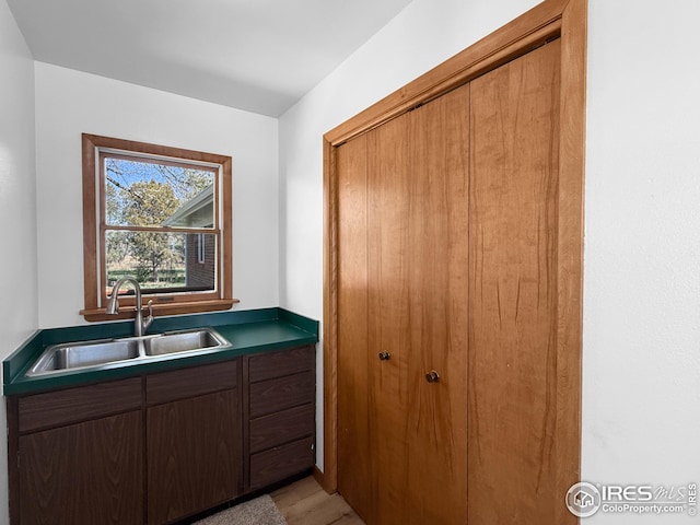 26237 County Road 65, Holyoke, CO 80734 - kitchen with a sink, light wood-style floors, and dark countertops