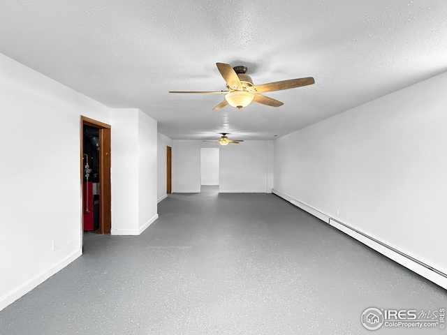 26237 County Road 65, Holyoke, CO 80734 - unfurnished room with ceiling fan, a baseboard heating unit, baseboards, a textured ceiling, and concrete flooring