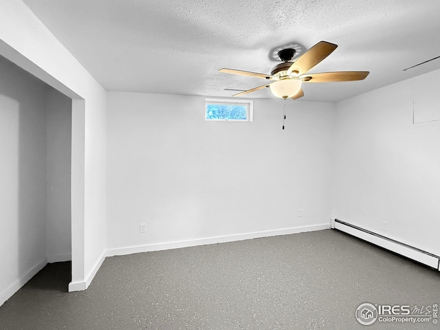 26237 County Road 65, Holyoke, CO 80734 - spare room featuring baseboard heating, a textured ceiling, baseboards, and ceiling fan