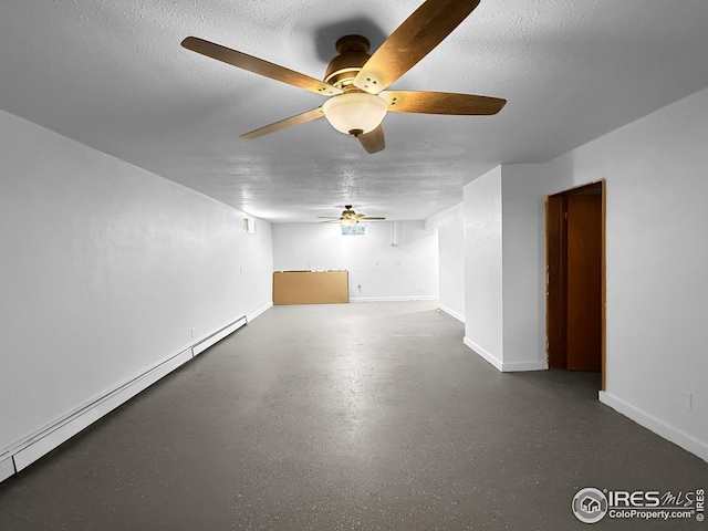 26237 County Road 65, Holyoke, CO 80734 - spare room featuring a baseboard radiator, a ceiling fan, a textured ceiling, and baseboards