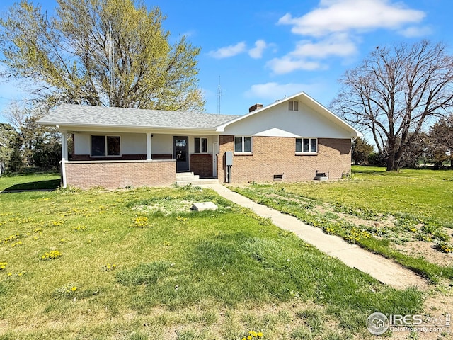 26237 County Road 65, Holyoke, CO 80734 - single story home featuring brick siding, a front lawn, and a chimney