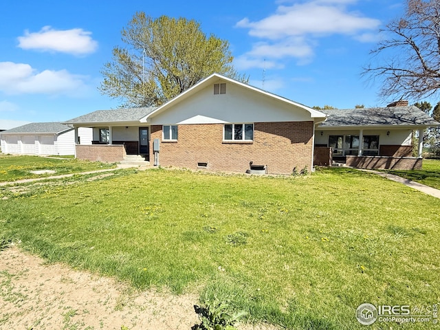26237 County Road 65, Holyoke, CO 80734 - rear view of property with brick siding, a yard, and a porch