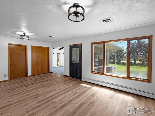 26237 County Road 65, Holyoke, CO 80734 - entrance foyer with a baseboard radiator, wood finished floors, and baseboards