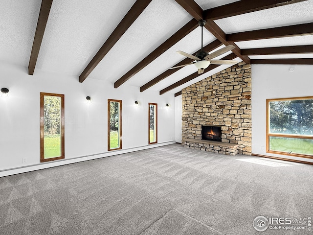 26237 County Road 65, Holyoke, CO 80734 - unfurnished living room featuring ceiling fan, plenty of natural light, carpet flooring, a textured ceiling, and baseboard heating