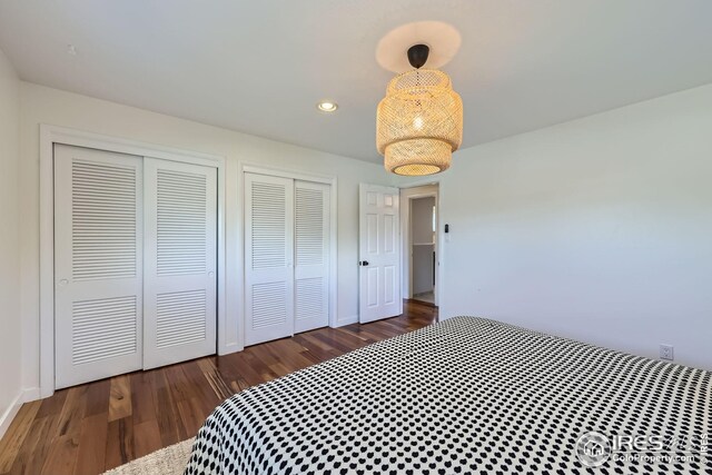 bedroom with recessed lighting, baseboards, multiple closets, and wood finished floors