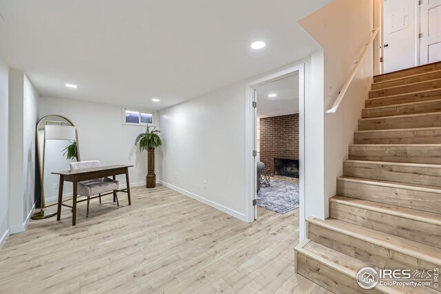 office area with recessed lighting, baseboards, a fireplace, and light wood finished floors