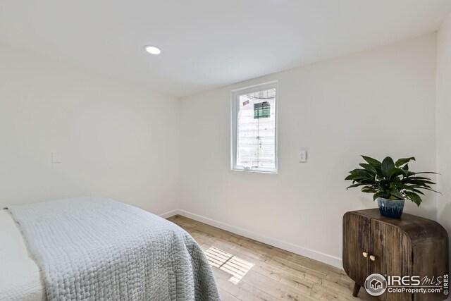bedroom featuring baseboards, recessed lighting, and wood finished floors