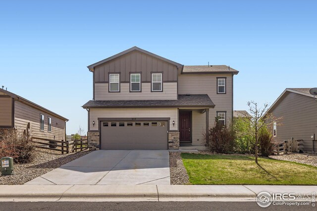 357 Chipman Dr, Windsor, CO 80550 - view of front of house featuring fence, a garage, board and batten siding, a front yard, and driveway