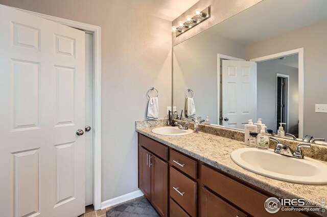 357 Chipman Dr, Windsor, CO 80550 - full bath featuring a sink, baseboards, and double vanity