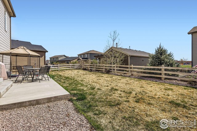 357 Chipman Dr, Windsor, CO 80550 - view of yard featuring a fenced backyard, a patio, a gazebo, and a residential view