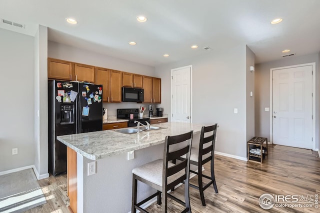 357 Chipman Dr, Windsor, CO 80550 - kitchen with a sink, light wood-style floors, recessed lighting, visible vents, and black appliances