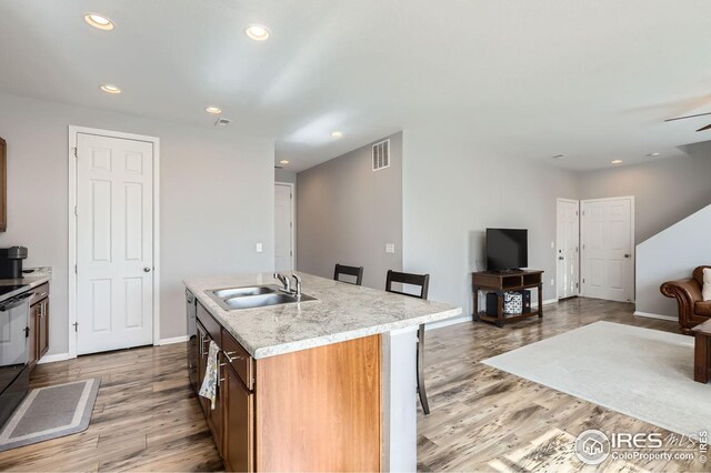 357 Chipman Dr, Windsor, CO 80550 - kitchen with a sink, light countertops, light wood-type flooring, and visible vents