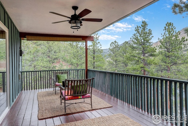 wooden terrace with ceiling fan and a mountain view
