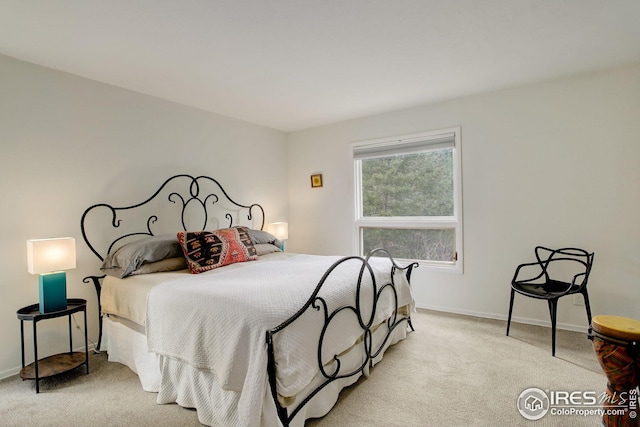 carpeted bedroom featuring baseboards