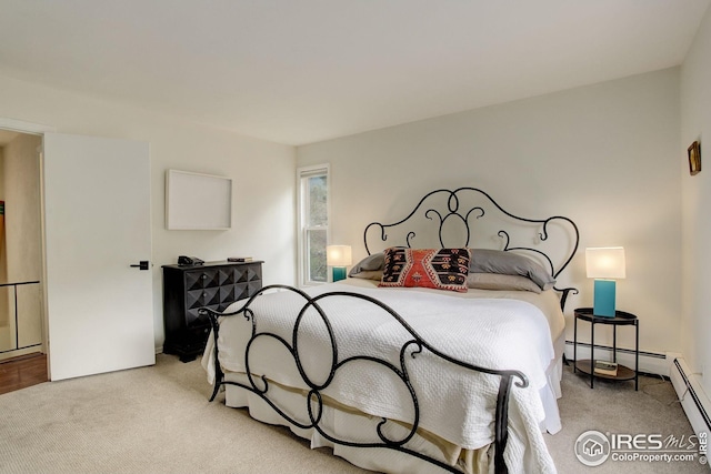 bedroom featuring a baseboard heating unit and light carpet