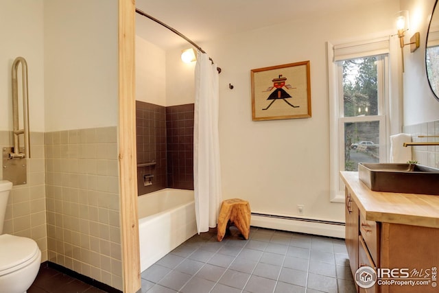 bathroom with tile patterned flooring, vanity, toilet, tile walls, and a baseboard radiator