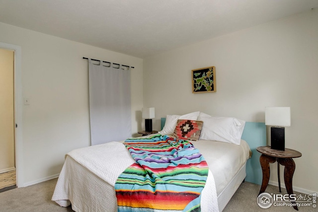 carpeted bedroom with baseboards
