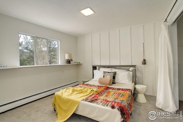 carpeted bedroom with a baseboard radiator