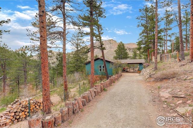 chalet / cabin with a mountain view and driveway