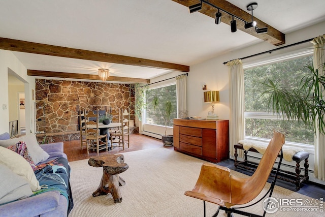 living area featuring a baseboard heating unit and beam ceiling