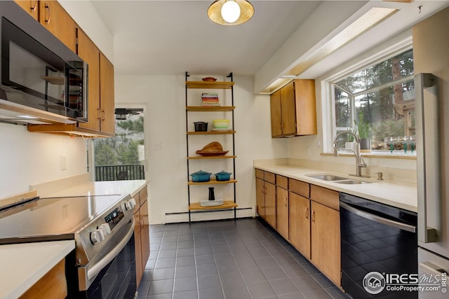 kitchen featuring open shelves, dark tile patterned floors, a baseboard heating unit, a sink, and black appliances