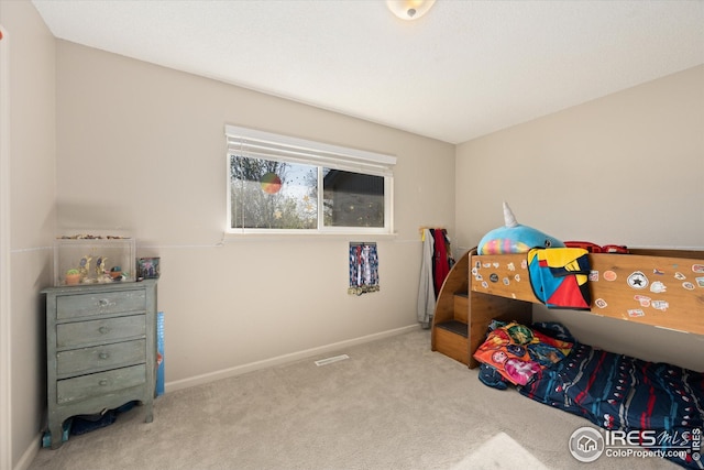 bedroom with carpet floors and baseboards