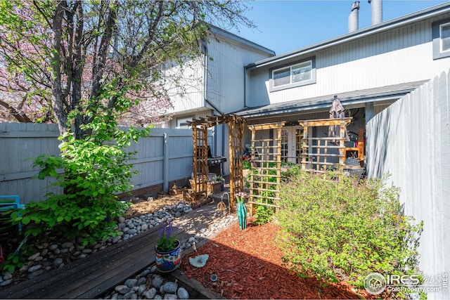 rear view of house with a fenced backyard