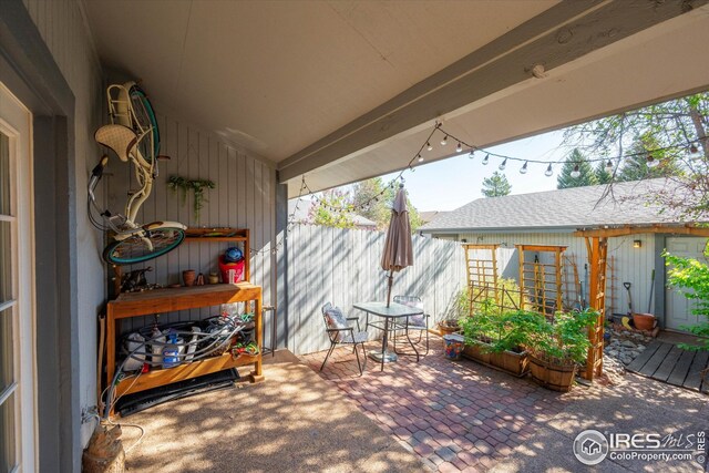 view of patio / terrace featuring fence
