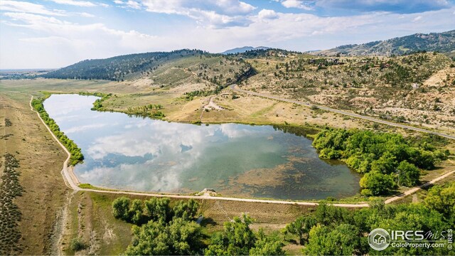 bird's eye view with a water and mountain view