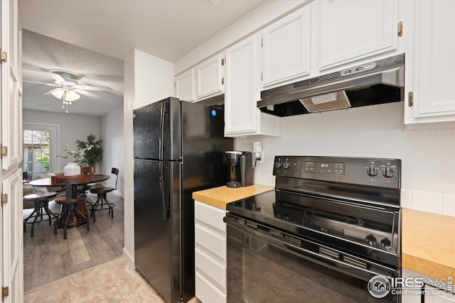kitchen featuring under cabinet range hood, white cabinetry, ceiling fan, and black appliances