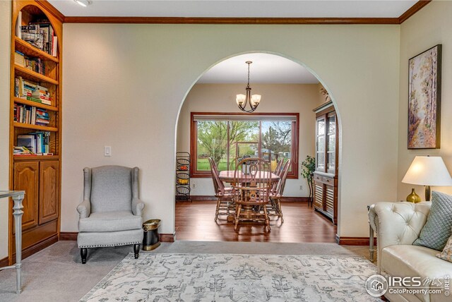 7628 Estate Cir, Niwot, CO 80503 - dining room with baseboards, arched walkways, a notable chandelier, and ornamental molding