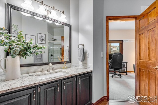 7628 Estate Cir, Niwot, CO 80503 - bathroom featuring vanity, baseboards, an enclosed shower, and tasteful backsplash