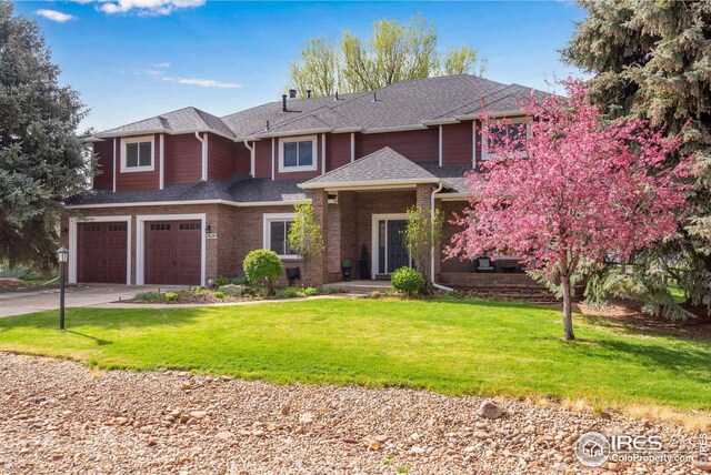 7628 Estate Cir, Niwot, CO 80503 - view of front of house featuring a shingled roof, an attached garage, driveway, and a front lawn
