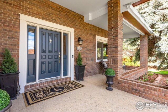 7628 Estate Cir, Niwot, CO 80503 - entrance to property featuring a porch and brick siding