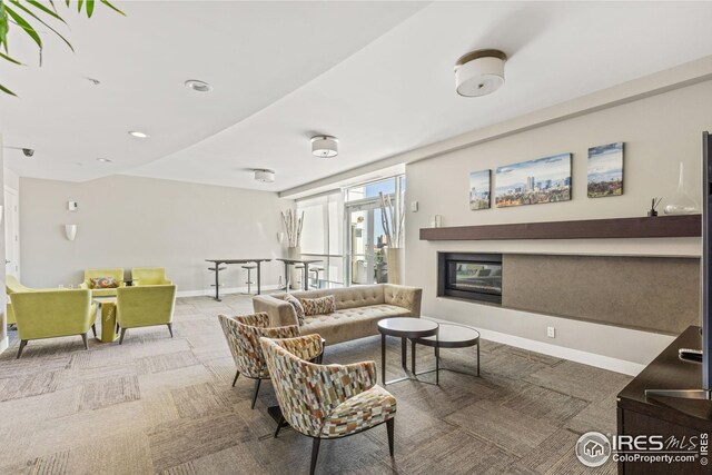 2001 Lincoln St Unit 2113, Denver, CO 80202 - carpeted living area with baseboards and a glass covered fireplace