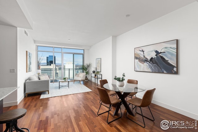 2001 Lincoln St Unit 2113, Denver, CO 80202 - dining area featuring a wall of windows, wood finished floors, and baseboards