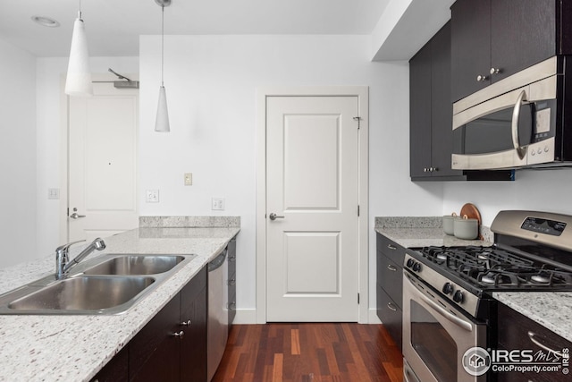 2001 Lincoln St Unit 2113, Denver, CO 80202 - kitchen with stainless steel appliances, a sink, dark wood finished floors, and hanging light fixtures