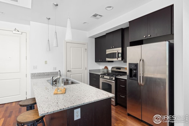 2001 Lincoln St Unit 2113, Denver, CO 80202 - kitchen featuring stainless steel appliances, a sink, a breakfast bar, a peninsula, and hanging light fixtures