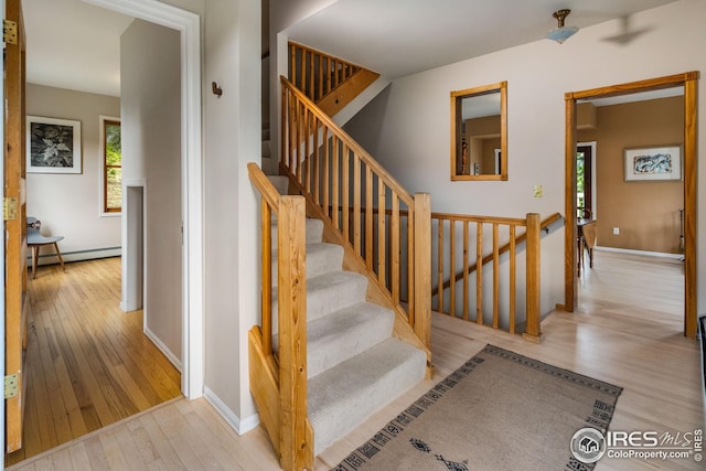 18 Pine St, Jamestown, CO 80455 - stairs with hardwood / wood-style floors, plenty of natural light, and baseboard heating